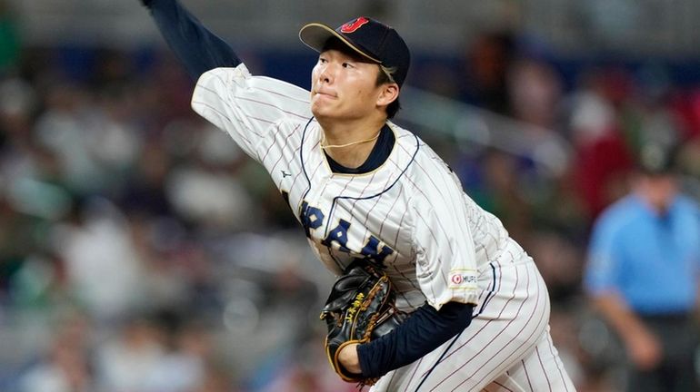 Yoshinobu Yamamoto delivers a pitch during the fifth inning of...