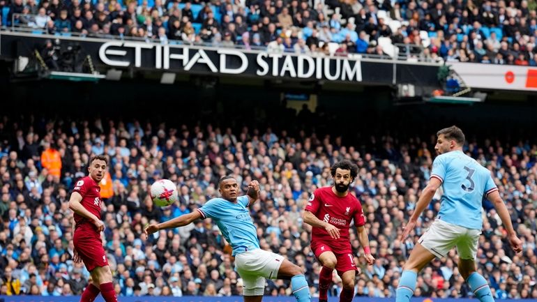 Liverpool's Mohamed Salah, second from right, scores his side's opening...