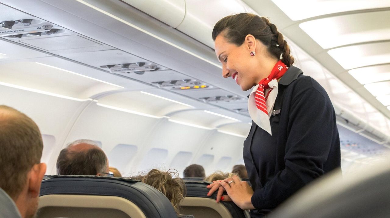 Flight Attendant Sitting In A Jump Seat With A Telephone High-Res Stock  Photo - Getty Images