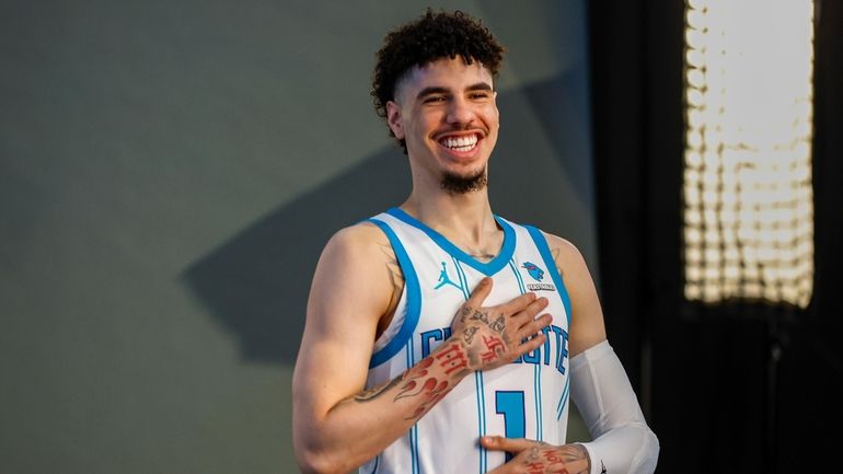 Charlotte Hornets guard LaMelo Ball laughs at the NBA basketball's...