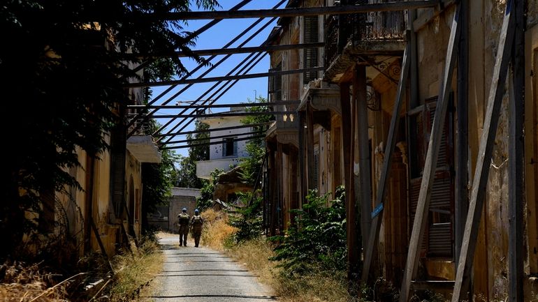 United Nations Peacekeepers walk inside the U.N.-controlled buffer zone in...