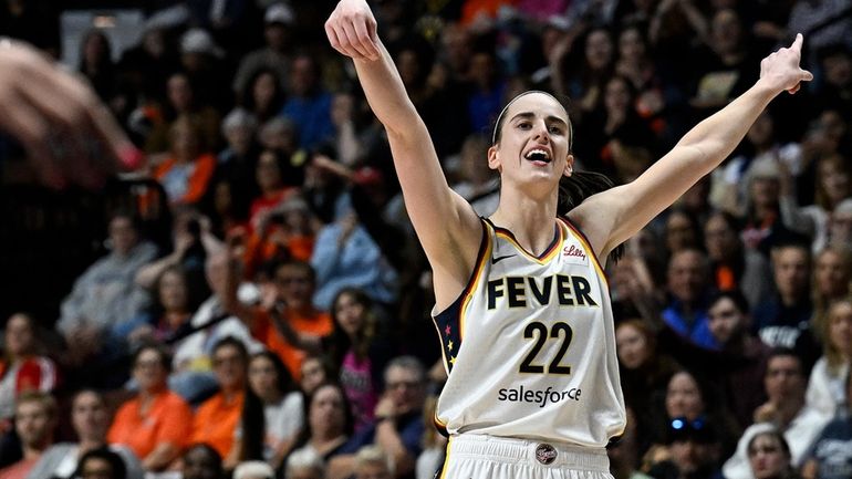 Indiana Fever guard Caitlin Clark (22) reacts after missing a...