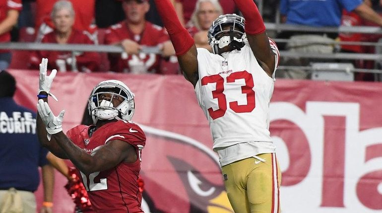 Cornerback Rashard Robinson of the 49ers tips a pass intended...