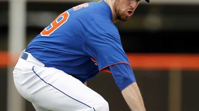 New York Mets first baseman Ike Davis handles a grounder...