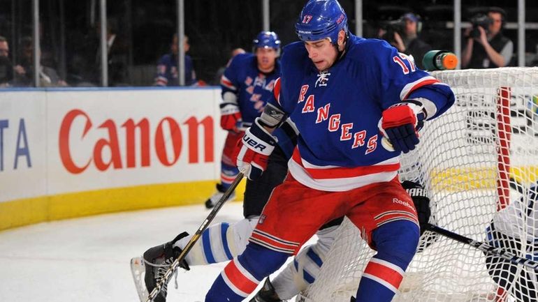 Brandon Dubinsky of the Rangers controls the puck against the...