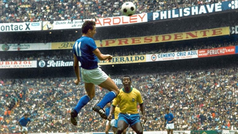 Italian forward Gigi Riva, heads the ball as Brazilian star...