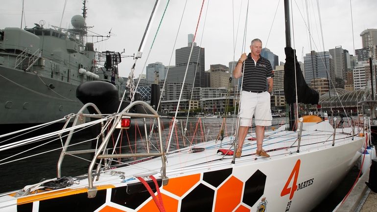 Sailor Craig McCarthy stands on the deck of the yacht...