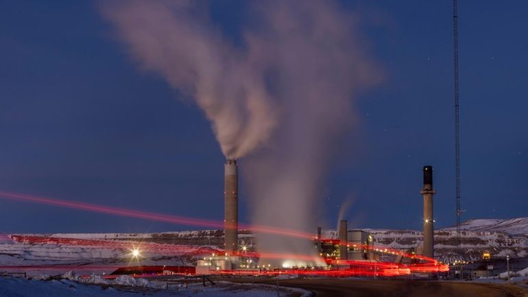 Taillights trace the path of a motor vehicle at the...