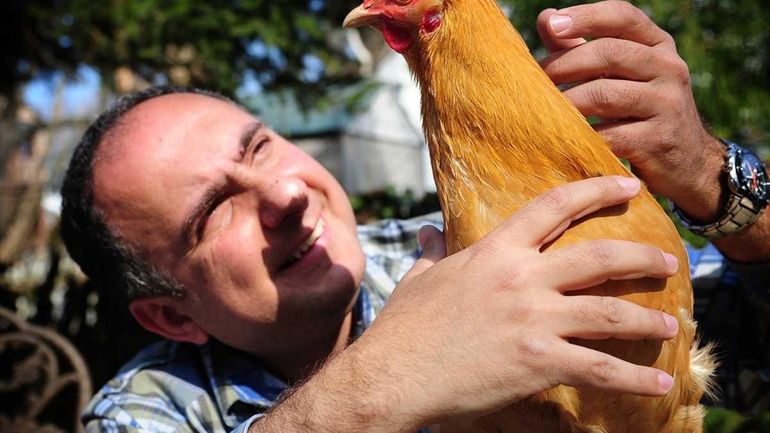 Alfred Basal with one of his pet chickens in the...