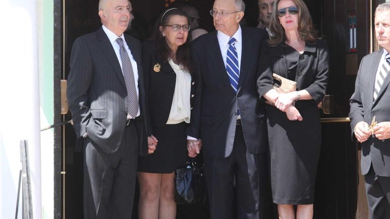 Former Sen. Alfonse D'Amato and family watch as the coffin...