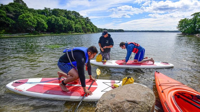 Nick Barbera, center, owner of Stony Brook Harbor Kayak and...