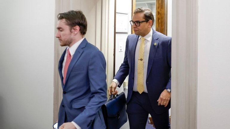 Rep. George Santos (R-Nassau/Queens), right, leaves his office with Chief of...