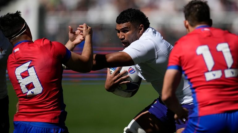 Samoa's Taleni Junior Agaese Seu, center, fight for the ball...