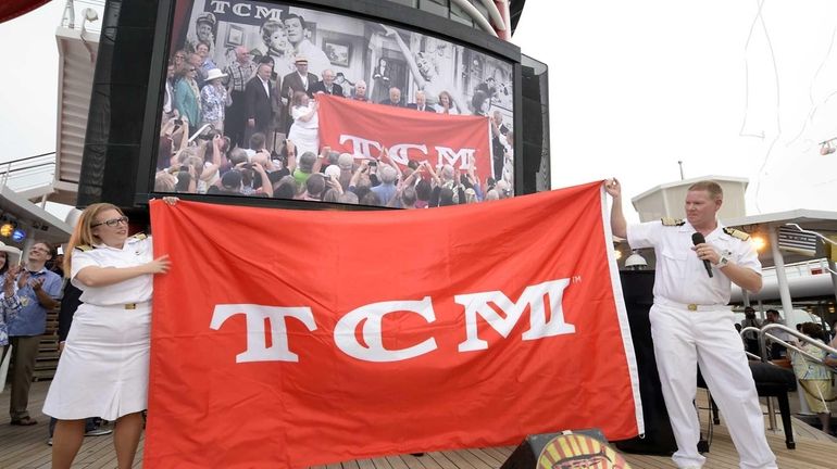 Disney Magic crew members unfurl the banner as the 2014...