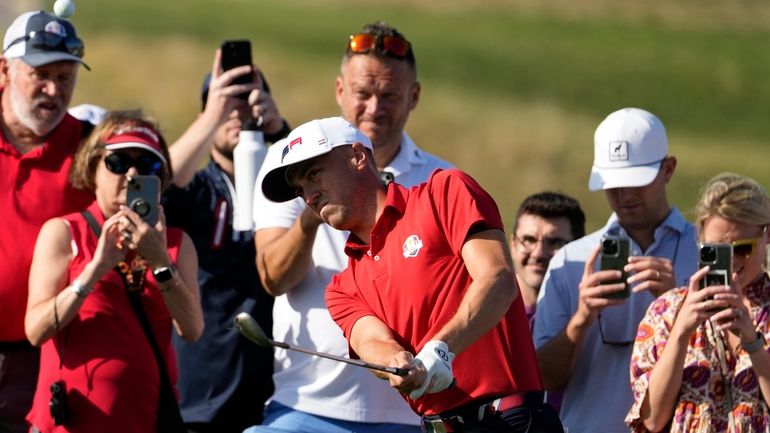 United States' Justin Thomas chips onto the 10th green during...