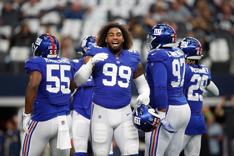 New York Giants linebacker Lorenzo Carter (59) celebrates intercepting a  Dallas Cowboys' Dak Prescott pass in the first half of an NFL football game  in Arlington, Texas, Sunday, Oct. 10, 2021. (AP