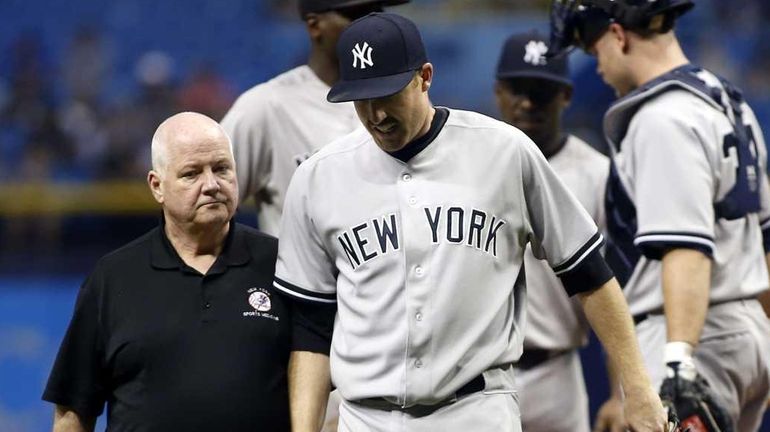 Pitcher Chase Whitley #39 of the New York Yankees leaves...