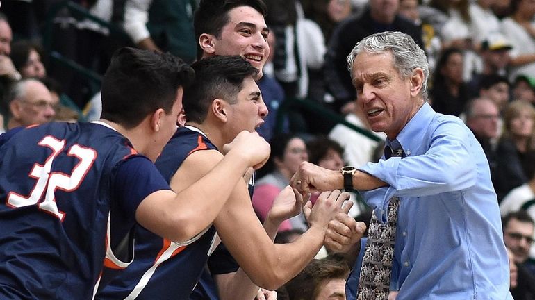 Manhasset head coach George Bruns congratulates his players as they...