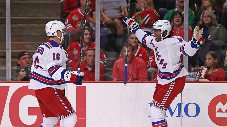 Derick Brassard and Anthony Duclair of the Rangers celebrate Duclair's...