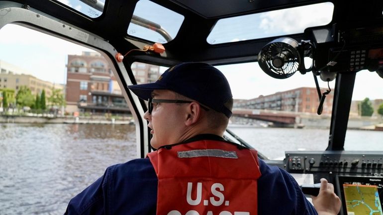 Boson's mate second class Tyler Boon navigates a U.S. Coast...