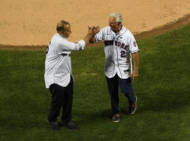 The New York Yankees and the New York Mets shake hands before lining up  together along the baselines for the 20th anniversary of the 9/11 terrorist  attacks before a baseball game on