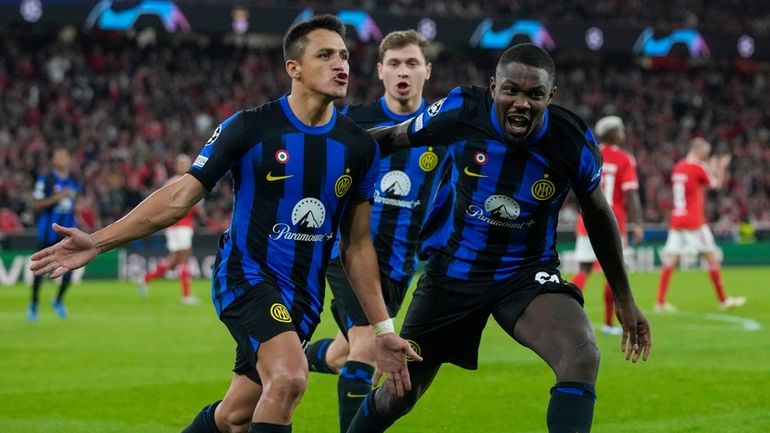 Inter Milan's Alexis Sanchez, left, celebrates with his teammates after...