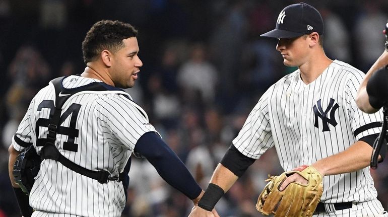 Yankees catcher Gary Sanchez and second baseman DJ LeMahieu, right,...