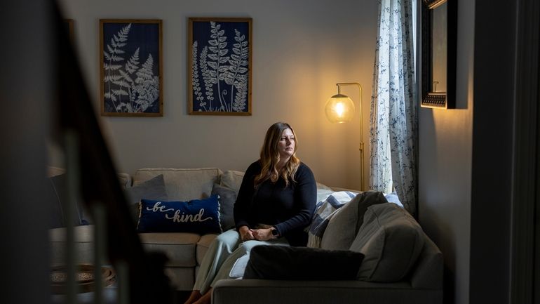 Melissa Hartman poses for a portrait inside of her home,...