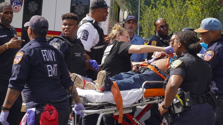 First responders tend to a man injured during a shooting...