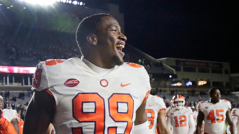 Clemson defensive end Clelin Ferrell (99) and teammates celebrate their...