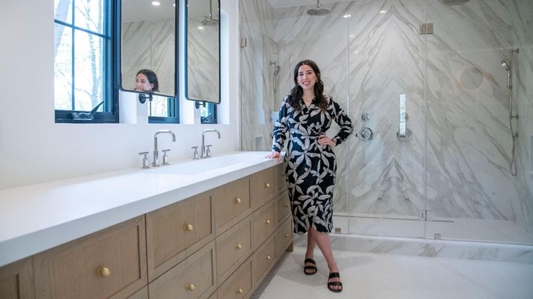 Interior designer Noelle Paquette stands in the master bathroom of...