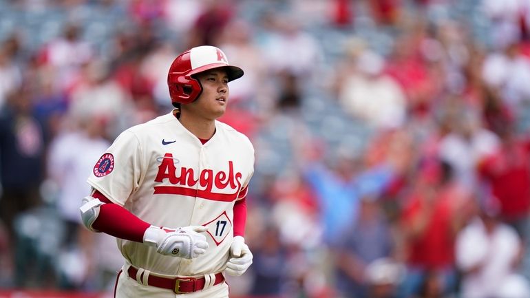 Los Angeles Angels' Shohei Ohtani runs the bases after hitting...