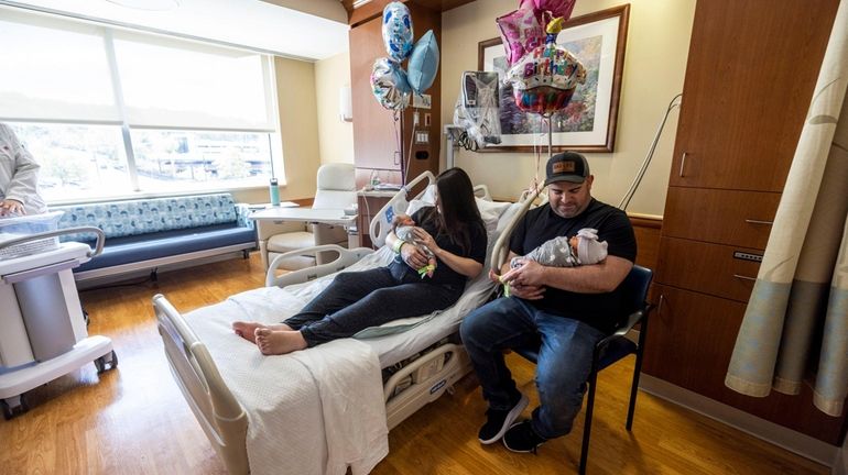 Keri and Michael Feldman with their newborn twins, Austin, left, and...