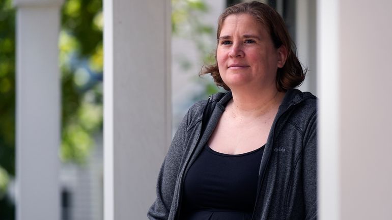 Rebecca Wood stands for a portrait outside her home, Friday,...