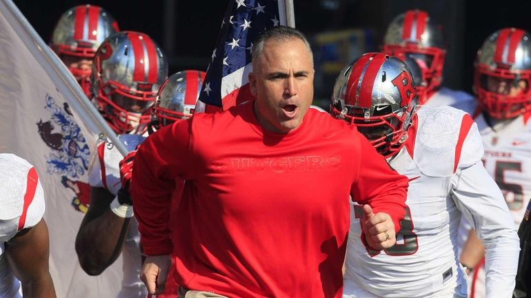 Rutgers head coach Kyle Flood leads his team onto the...