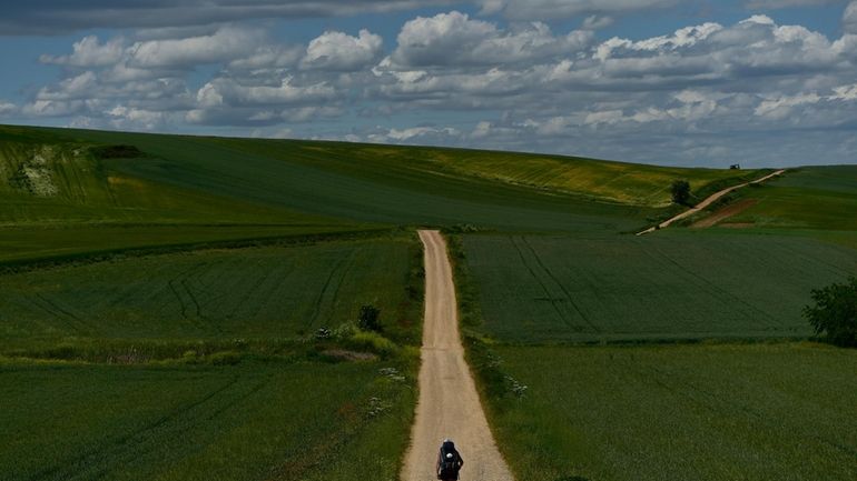 A pilgrim walks during a stage of "Camino de Santiago"...