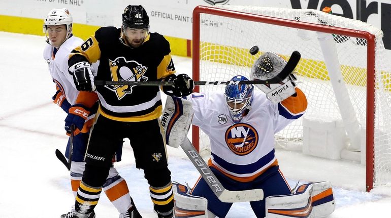 Pittsburgh Penguins' Zach Aston-Reese deflects the puck over the head...