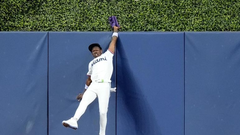 Miami Marlins center fielder Jazz Chisholm cannot get to a...