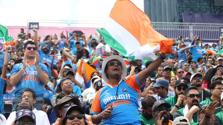 Fans of India celebrate a score against Pakistan during the...