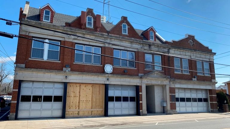 Boarded-up bay doors at the Inwood Fire Department station, Sunday...