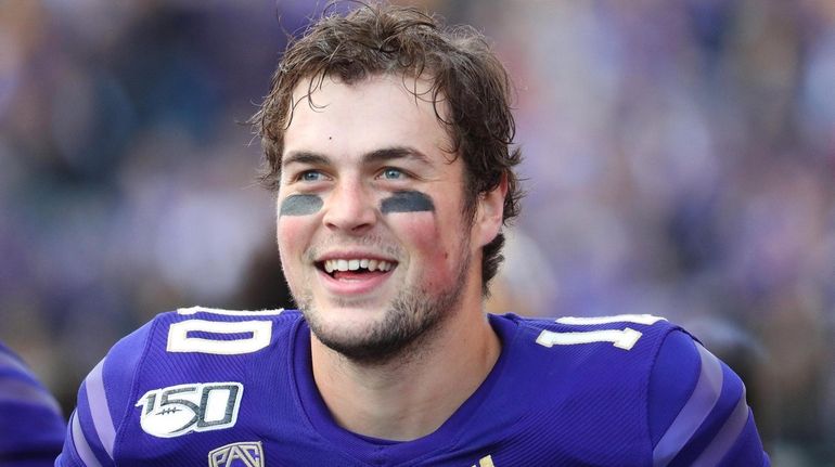 Jacob Eason #10 of the Washington Huskies smiles after throwing...