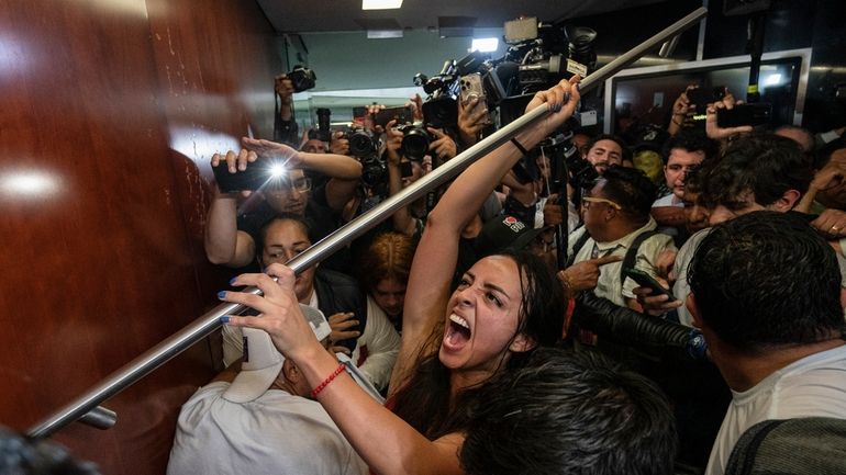 Protesters attempt to break into a room in the Senate...