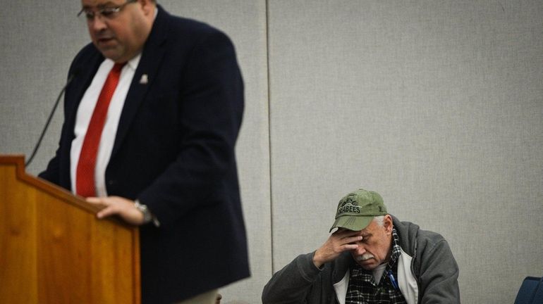 Bill Pearson, of North Patchogue, right, who opposes the proposed...