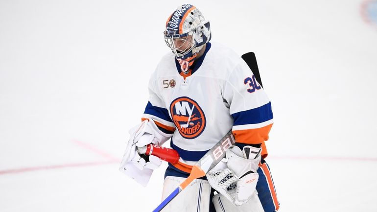 Islanders goaltender Ilya Sorokin skates towards the bench after an...