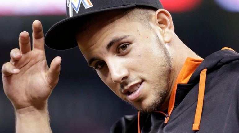 Miami Marlins pitcher Jose Fernandez replaces his cap after the...