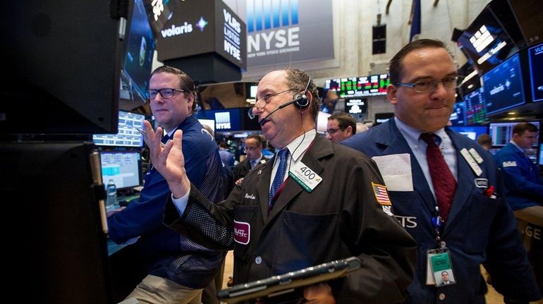 Traders work on the floor of the New York Stock...