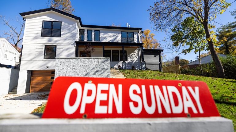 A "For Sale" sign outside a single-family home in Bethesda, Md.