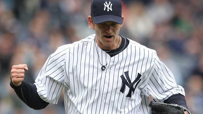 A.J. Burnett #34 of the New York Yankees celebrates a...