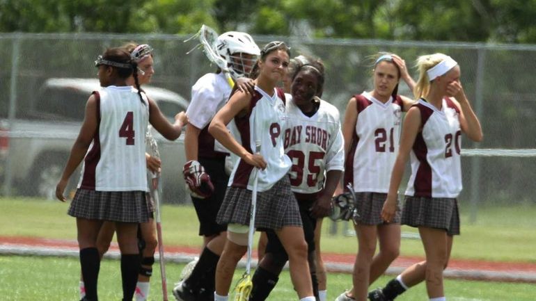 Bay Shore's girls lacrosse team consoles each other after losing...