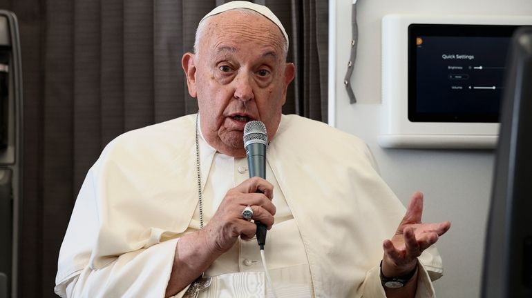 Pope Francis holds a news conference aboard the papal plane...